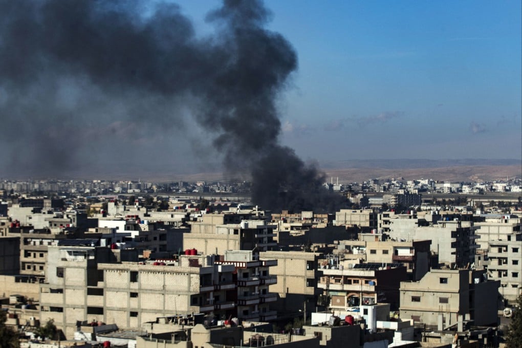 Smokes billows in Qamishli in northeastern Syria near the border with Turkey on December 25, amid Turkish air strikes in the area. Photo: AFP
