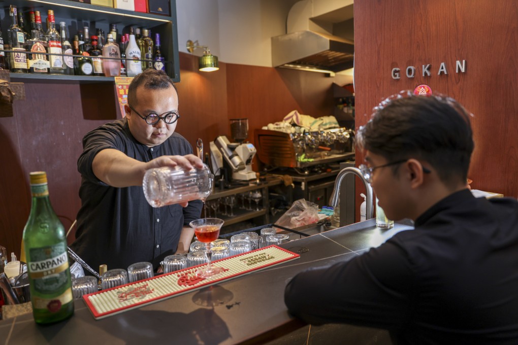 Derek Lam, part of the new generation of “slash pastors”, serves up a drink at a bar in Sheung Wan. Photo: Yik Yeung-man