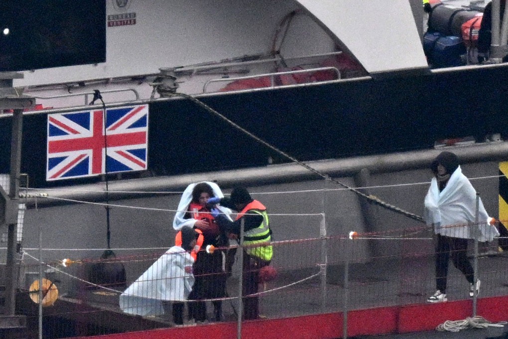 Migrants with children picked up at sea while attempting to cross the English Channel from France on January 13. Photo: AFP