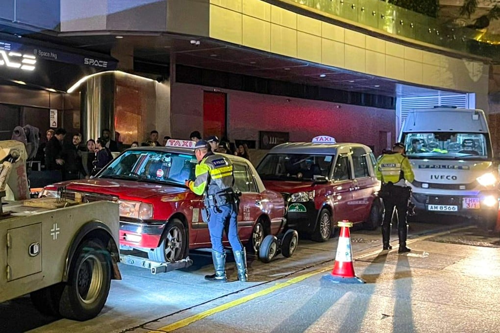 Police officers check taxis during the two-day crackdown on illegal cabby activity. Photo: Handout