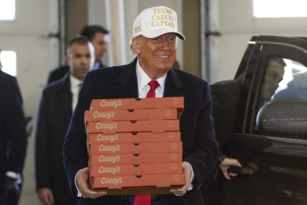 Donald Trump delivering pizzas to firefighters in Waukee, Iowa. The former US president implored supporters to brave frigid temperatures and deliver him a decisive victory in Monday’s Iowa caucuses. Photo: Associated Press