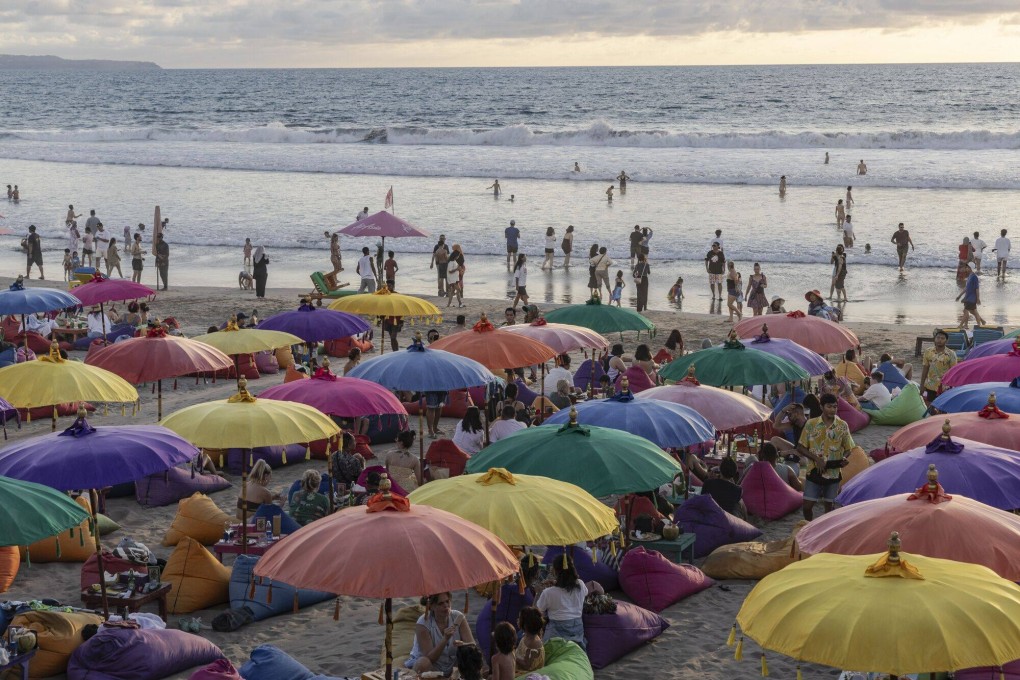 A packed beach in Seminyak, Bali. The Indonesian island will soon introduce a tourist tax to help tackle problems associated with mass tourism. But some say the move could drive visitors to other, cheaper Southeast Asian destinations. Photo: Bloomberg