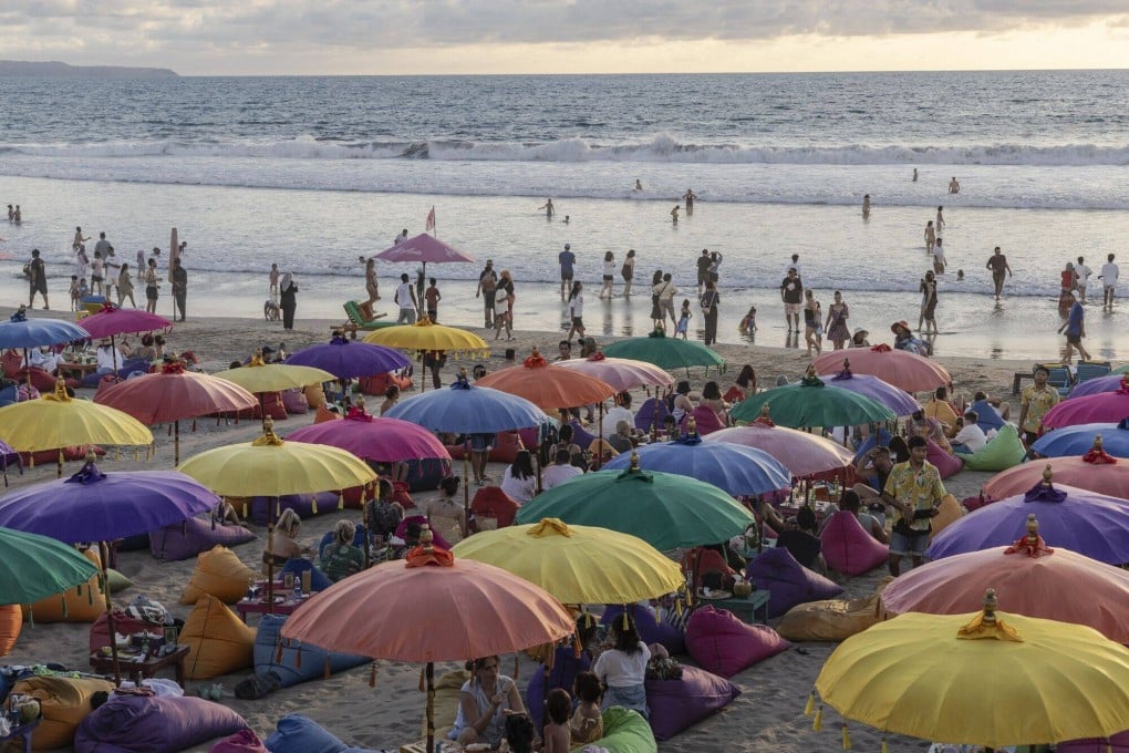A packed beach in Seminyak, Bali. The Indonesian island will soon introduce a tourist tax to help tackle problems associated with mass tourism. But some say the move could drive visitors to other, cheaper Southeast Asian destinations. Photo: Bloomberg