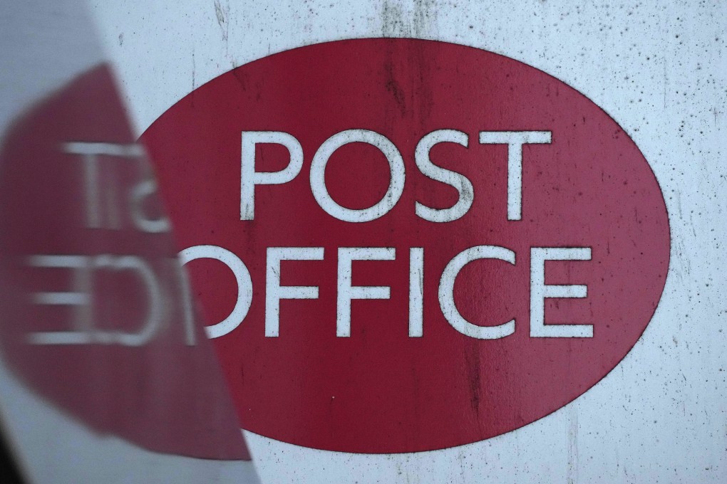 A post office logo on a shopfront on a street in London, on Tuesday. Photo: AP