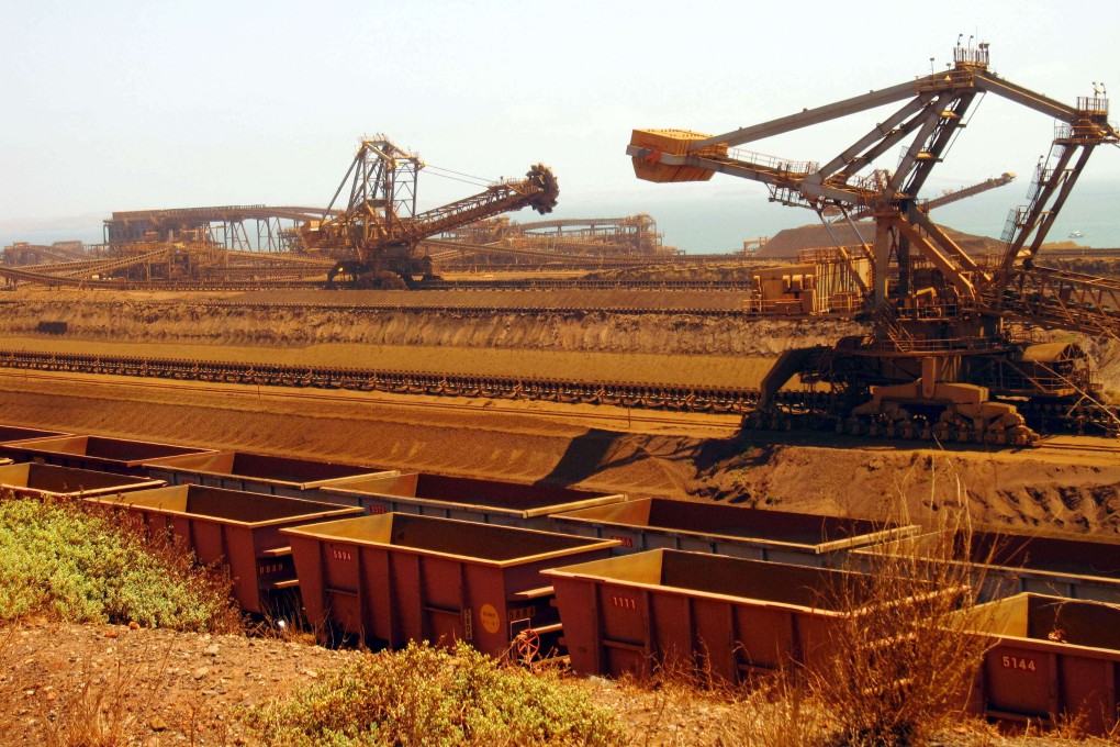 Machines mov iron ore to rail cars at Rio Tinto’s operations in Western Australia. The company expects global iron ore demand will rise almost a quarter by 2050, thanks in large part to China. Photo: AFP