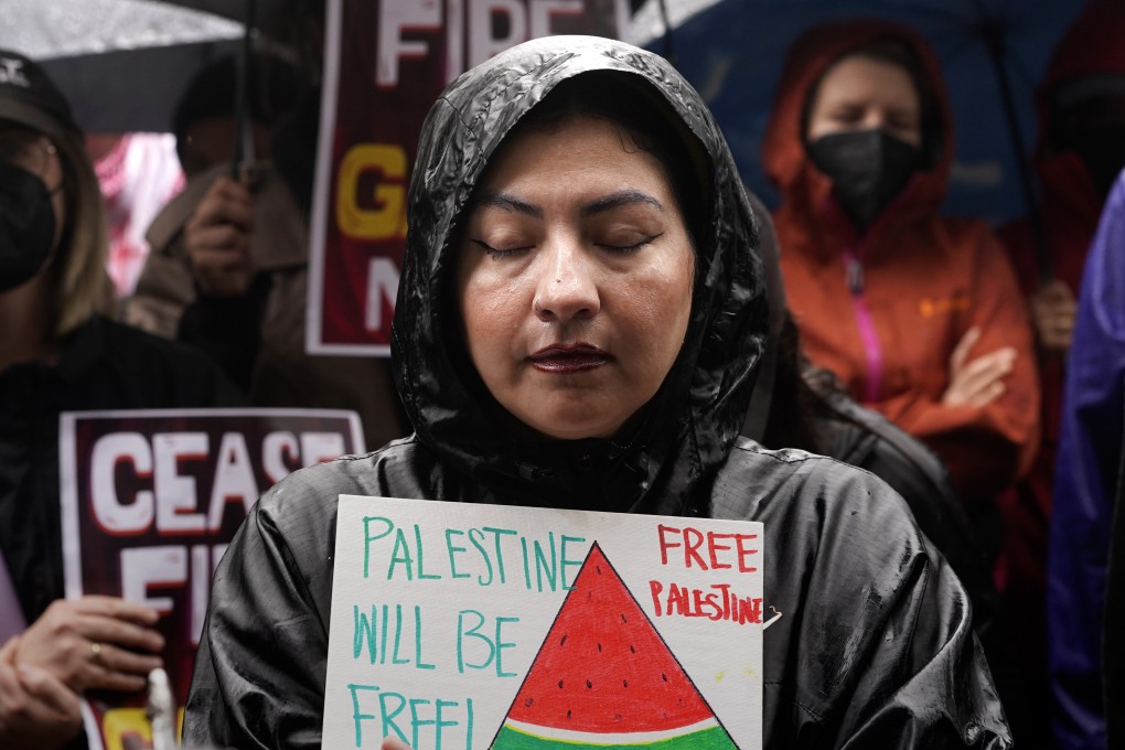 A woman holds a sign with watermelon imagery at a protest in Los Angeles in November. Photo: AP