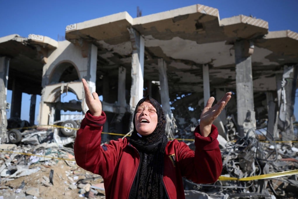 A Palestinian woman in front of a destroyed building in central Gaza Strip. Photo: AFP