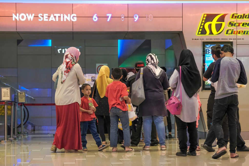 People waiting to enter the GSC cinema in Palm Mall shopping complex in Seremban, Malaysia. Photo: Shutterstock