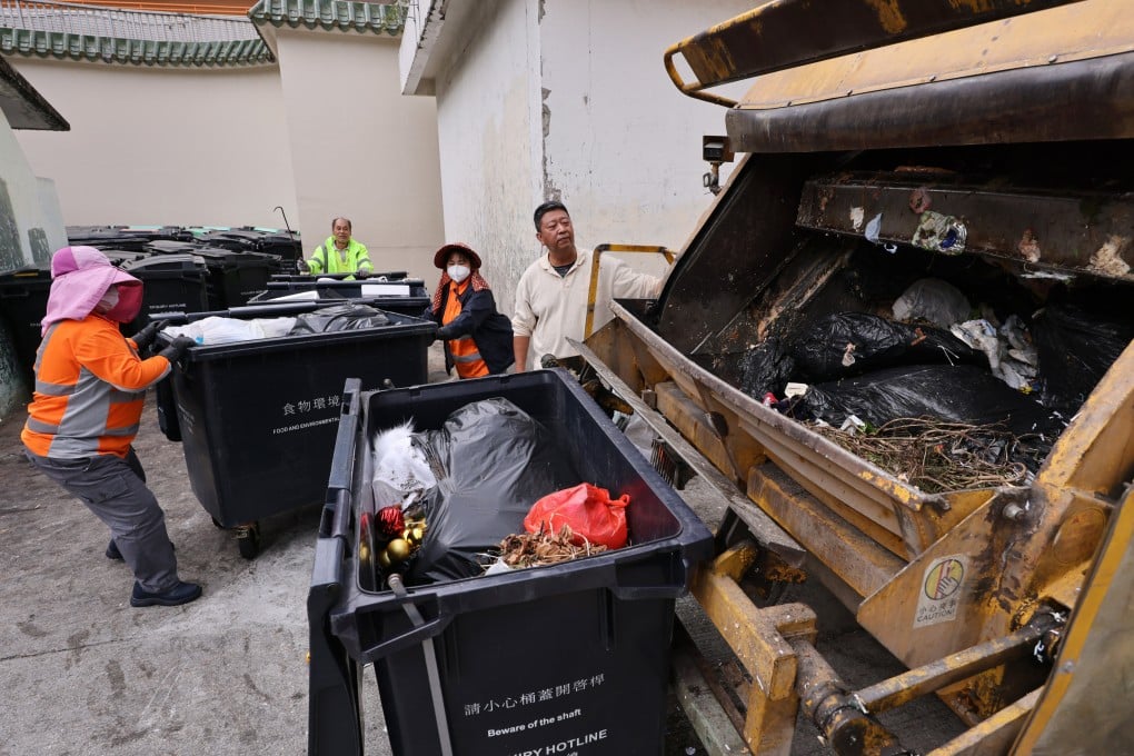 Workers handle rubbish in Tai Wai. City leader John Lee has told the environment minister to spread the word about the waste-charging scheme. Photo: May Tse