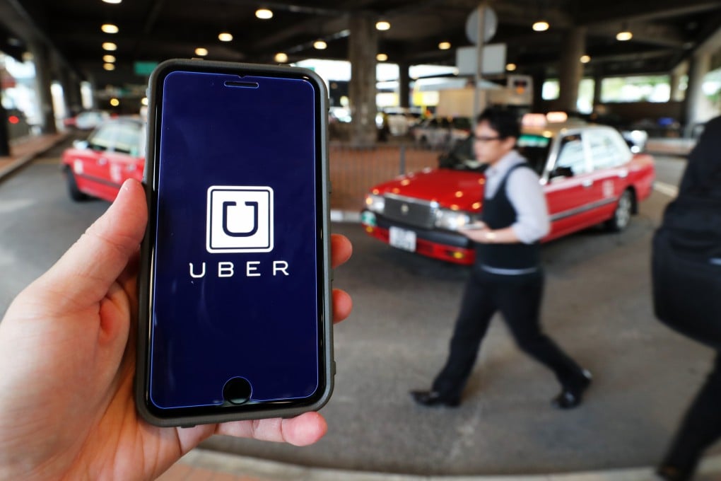 The Uber logo is displayed on a mobile phone in Hong Kong. Years since the ride-hailing app came to the city, police officers are still clamping down on unlicensed private hire driving. Photo: Winson Wong