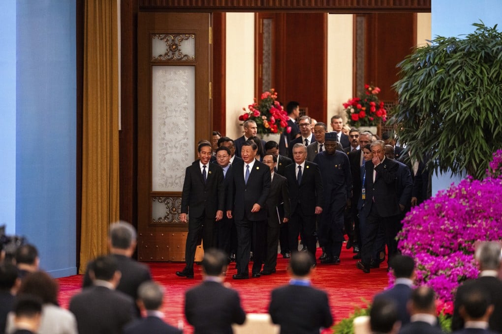 Chinese President Xi Jinping (third form left) chats with Indonesian President Joko Widodo (left) as they and other leaders arrive at the opening ceremony of the Belt and Road Forum at the Great Hall of the People in Beijing on October 18 last year. Photo: AP