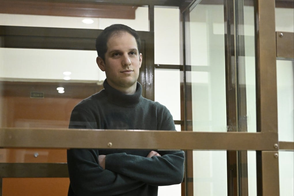 Wall Street Journal reporter Evan Gershkovich stands in a glass cage in a courtroom in Moscow in December 2023. Photo: AP