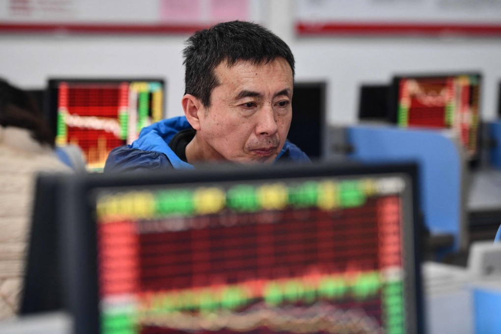 An investor looks at a screen showing stock market movements at a securities company in Fuyang in China’s eastern Anhui province. Photo: AFP