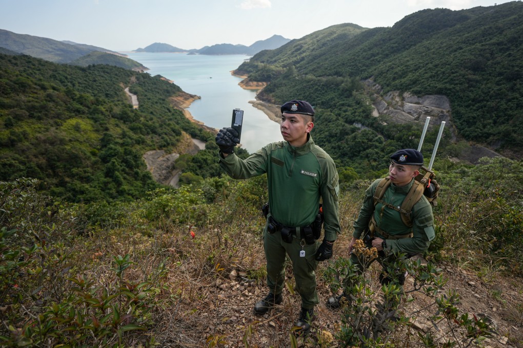 Police Tactical Unit officers demonstrate a rescue mission being carried out with the help of the “HKSOS” app. Photo: Eugene Lee