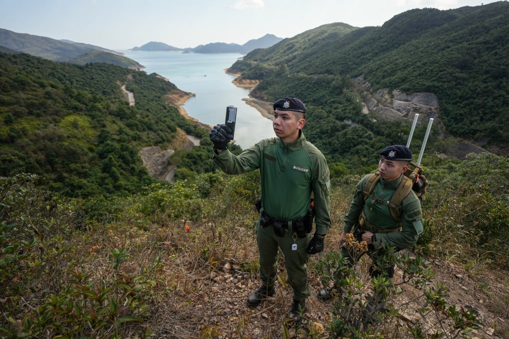 Police Tactical Unit officers demonstrate a rescue mission being carried out with the help of the “HKSOS” app. Photo: Eugene Lee