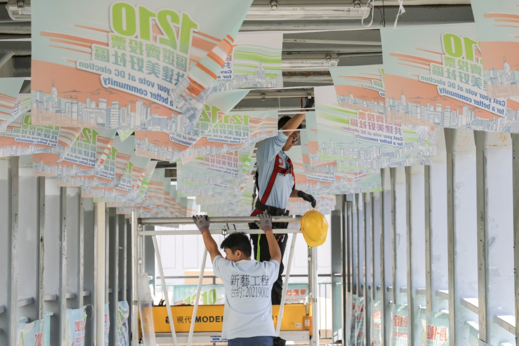 Workers in November hang up banners to promote the December 10 district council election. Photo: Jelly Tse