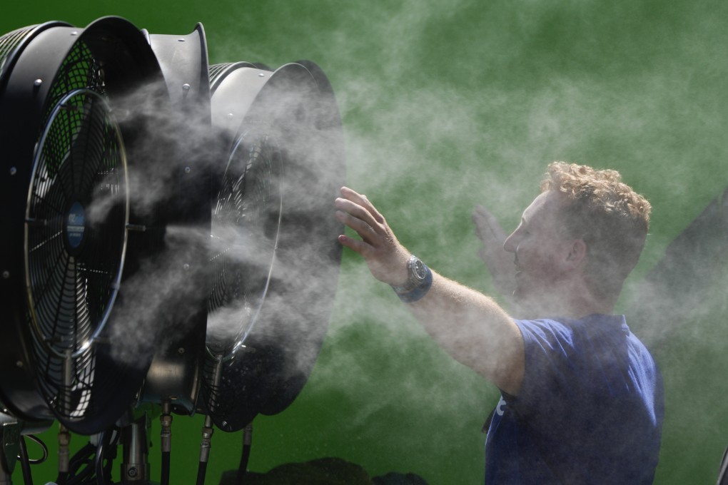 A spectator cools down during a practice day at the Australian Open in Melbourne. Parts of Australia are at “extreme” or “severe” levels of danger in the heatwave. Photo: AP