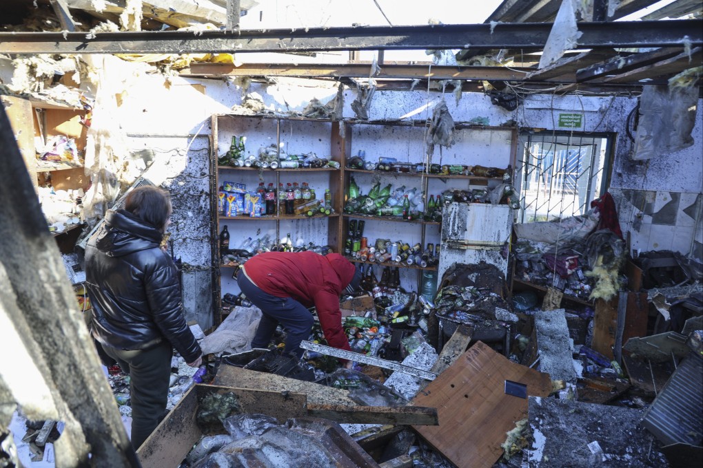 Locals at the scene following the shelling of the food market in Donetsk, eastern Ukraine. Photo: EPA-EFE