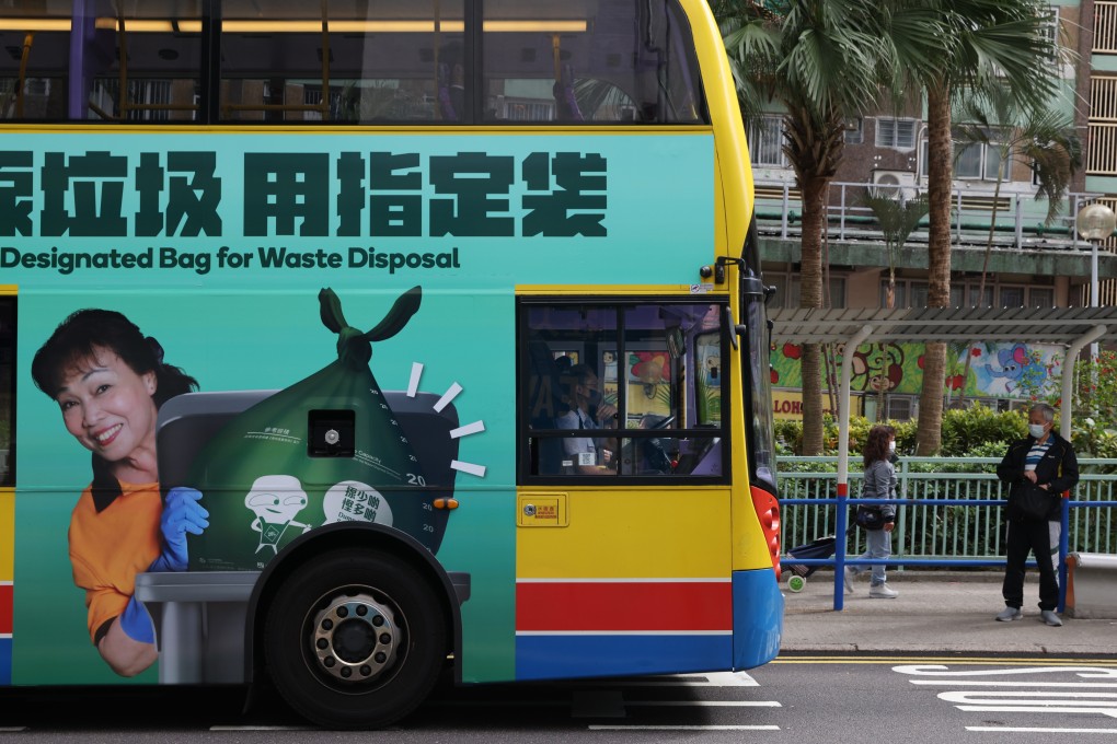 A government advertisement for the waste charging scheme is displayed on a bus in Chai Wan on January 19. Delaying the scheme might merely extend the period before the public can learn and therefore adapt to the scheme. Photo: Yik Yeung-man