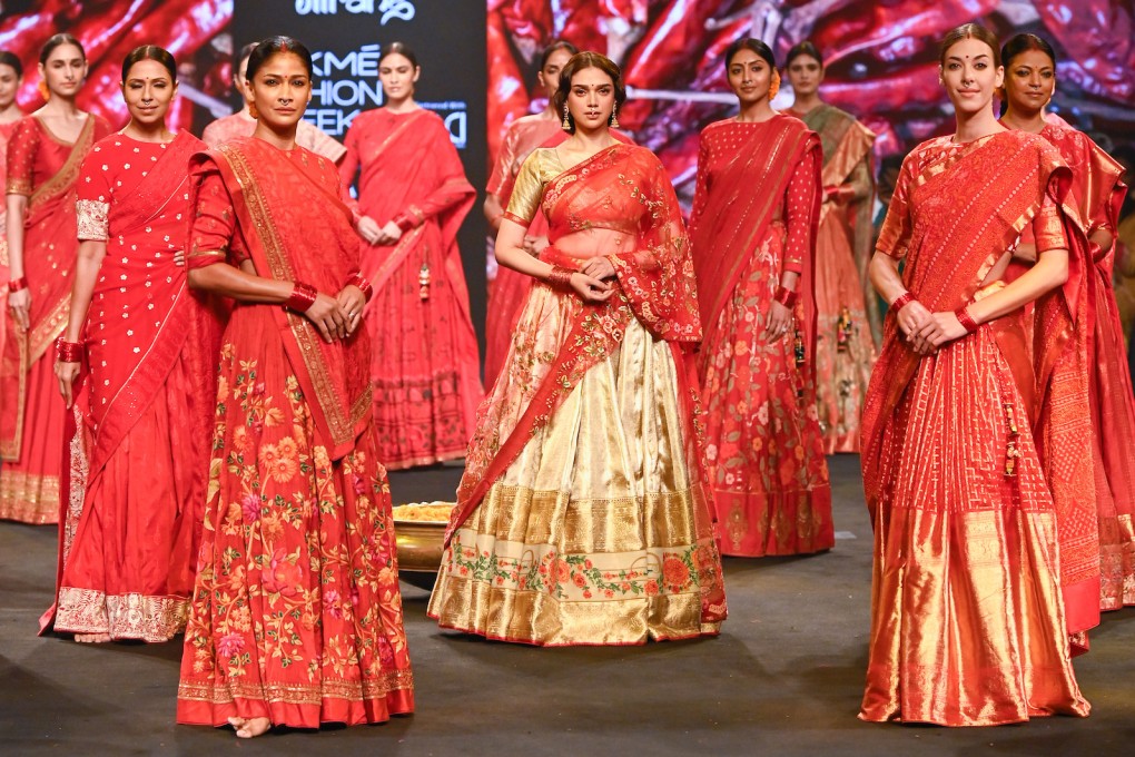 Indian actress Aditi Rao Hydari (centre) in a sari during a show at the FDCI x Lakmé Fashion Week 2022 in Mumbai, India. The Indian sari dates back centuries. Photo: Gaurang