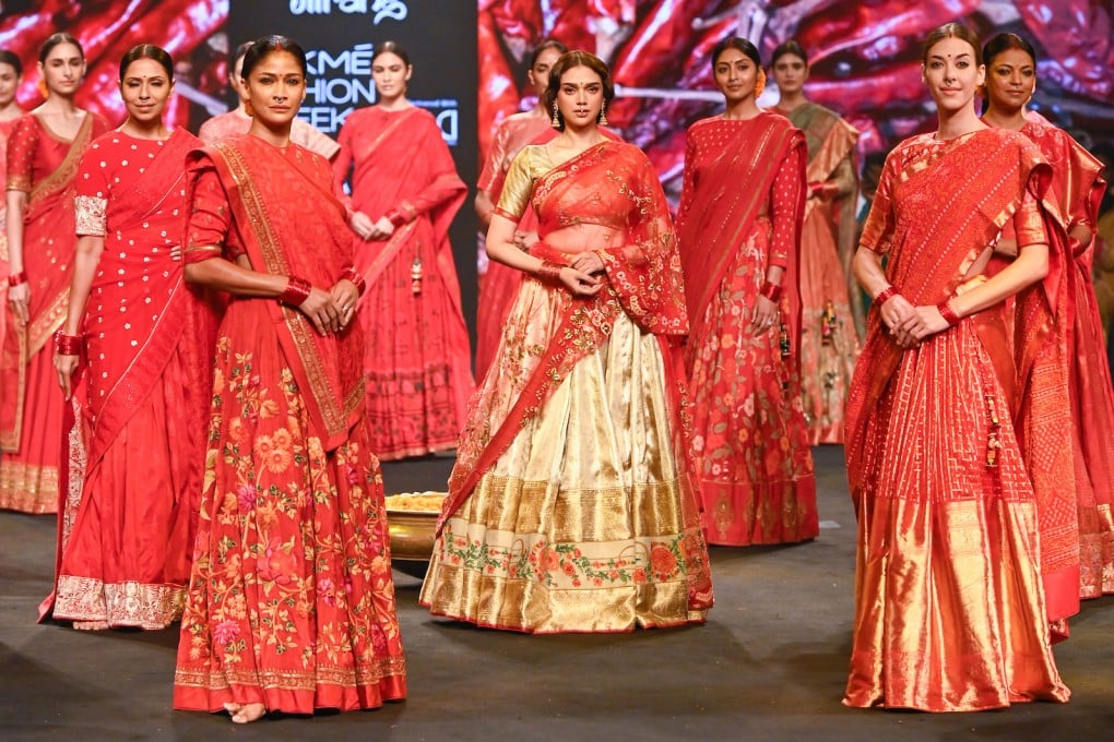 Indian actress Aditi Rao Hydari (centre) in a sari during a show at the FDCI x Lakmé Fashion Week 2022 in Mumbai, India. The Indian sari dates back centuries. Photo: Gaurang