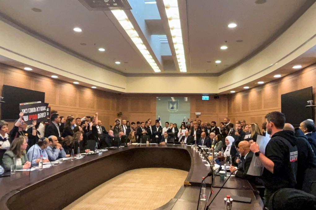 Relatives of Israelis, who have been held hostage by Hamas militants since October 7, storm a parliamentary committee session in Jerusalem, Israel on Monday. Photo: Reuters