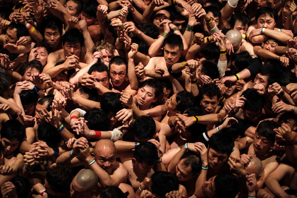Worshippers wait for the priest to throw the sacred batons during the 2017 “naked man” festival at Saidaiji Temple in Okayama, western Japan. Photo: AFP