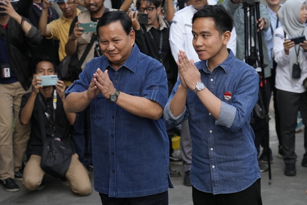 Indonesian presidential candidate Prabowo Subianto (left) and his running mate Gibran Rakabuming Raka, the eldest son of President Joko Widodo, greet reporters on arrival for the medical check-up required to stand in the presidential election, at Gatot Subroto Army Hospital in Jakarta, Indonesia, on October 26. The world’s third-largest democracy will hold its legislative and presidential elections on February 14. Photo: AP