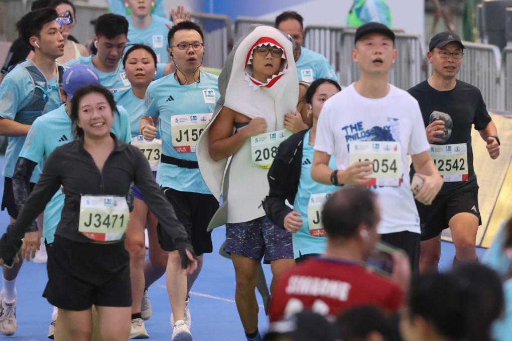 Runners arrive at the finish line of the Standard Chartered Hong Kong Marathon on Sunday. Photo: May Tse