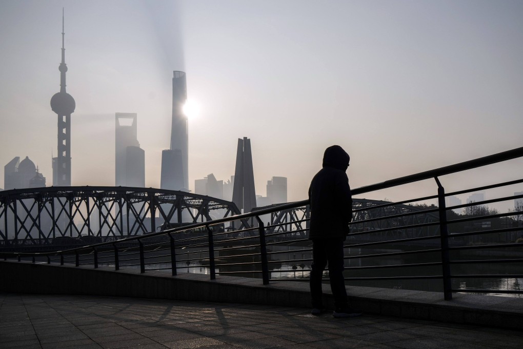 A pedestrian along a bridge passes buildings in Pudong’s Lujiazui Financial District in Shanghai on January 9, 2024. Photo: Bloomberg