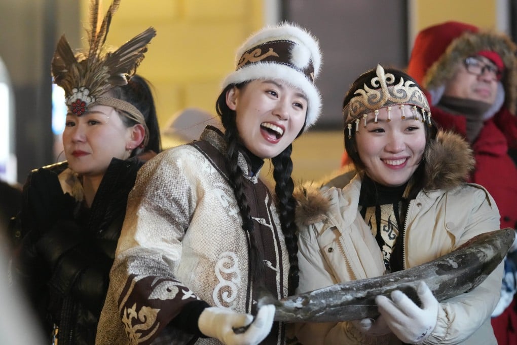 People wear traditional clothing of the Hezhe ethnic group of northeast China at an event in Heilongjiang province on January 6. Photo: Xinhua