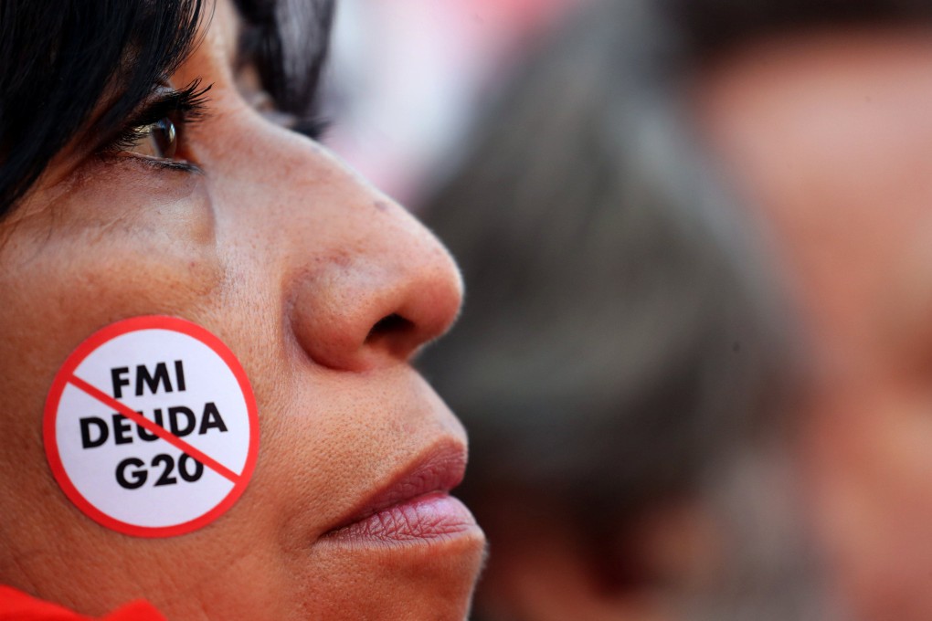 A demonstrator with an anti IMF debt and G20 sticker takes part in a protest against a G20 finance ministers’ meeting in Buenos Aires, Argentina, in July 2018. Over the past three years, 18 sovereign defaults have occurred in 10 developing countries – more than the total over the past two decades. Photos: Reuters