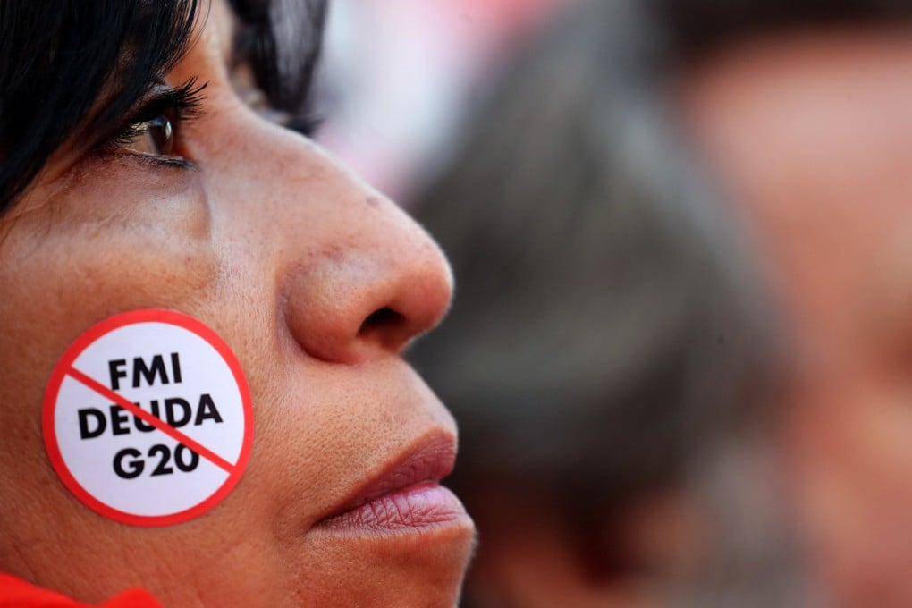 A demonstrator with an anti IMF debt and G20 sticker takes part in a protest against a G20 finance ministers’ meeting in Buenos Aires, Argentina, in July 2018. Over the past three years, 18 sovereign defaults have occurred in 10 developing countries – more than the total over the past two decades. Photos: Reuters