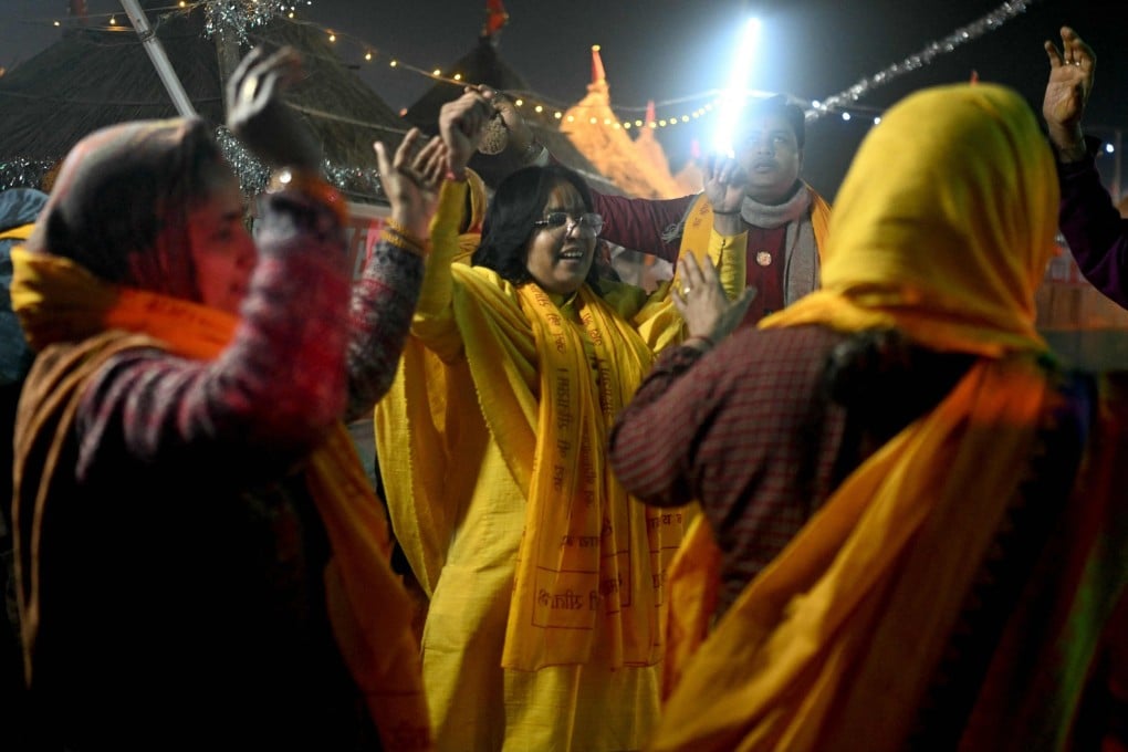 Devotees dance at the tent city built on the banks of Sarayu River in Ayodhya, after the opening of a Ram temple. Photo: AFP