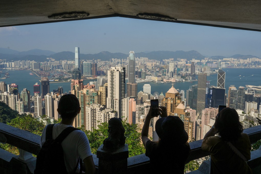 Tourists look down over Hong Kong’s business district from Tai Ping Shan Lion View Point Pavilion at The Peak on October 31, 2023. Photo: Sam Tsang