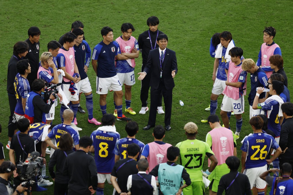 Japan head coach Hajime Moriyasu talks to his players after their win over Indonesia. Photo: Reuters