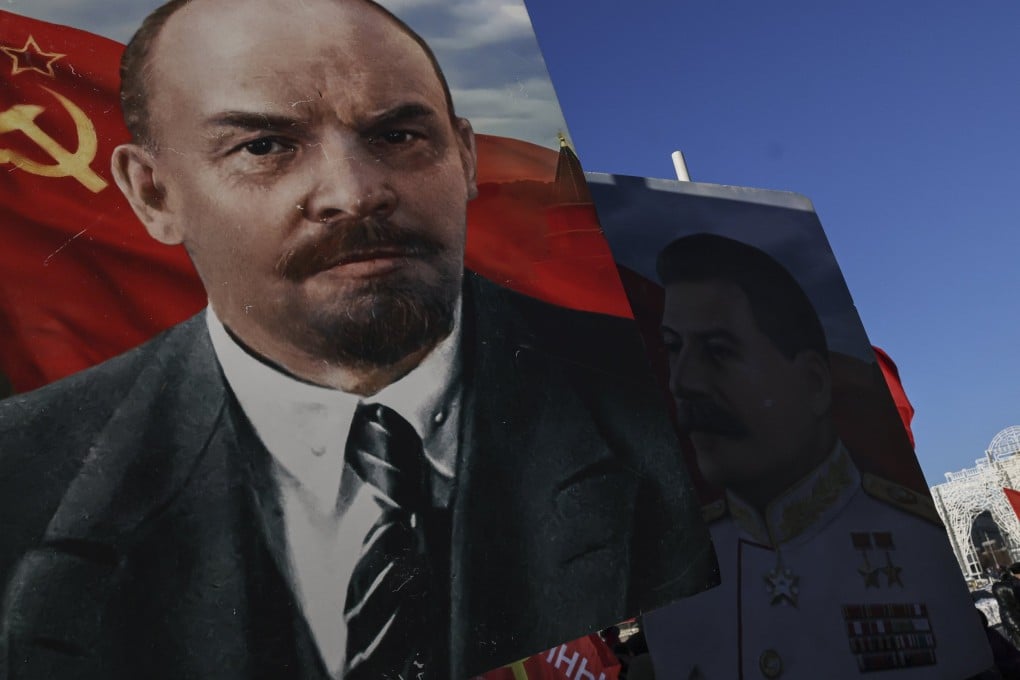Russian Communist party supporters in Moscow hold large portraits of Vladimir Lenin, 100 years after his death. Photo: EPA-EFE