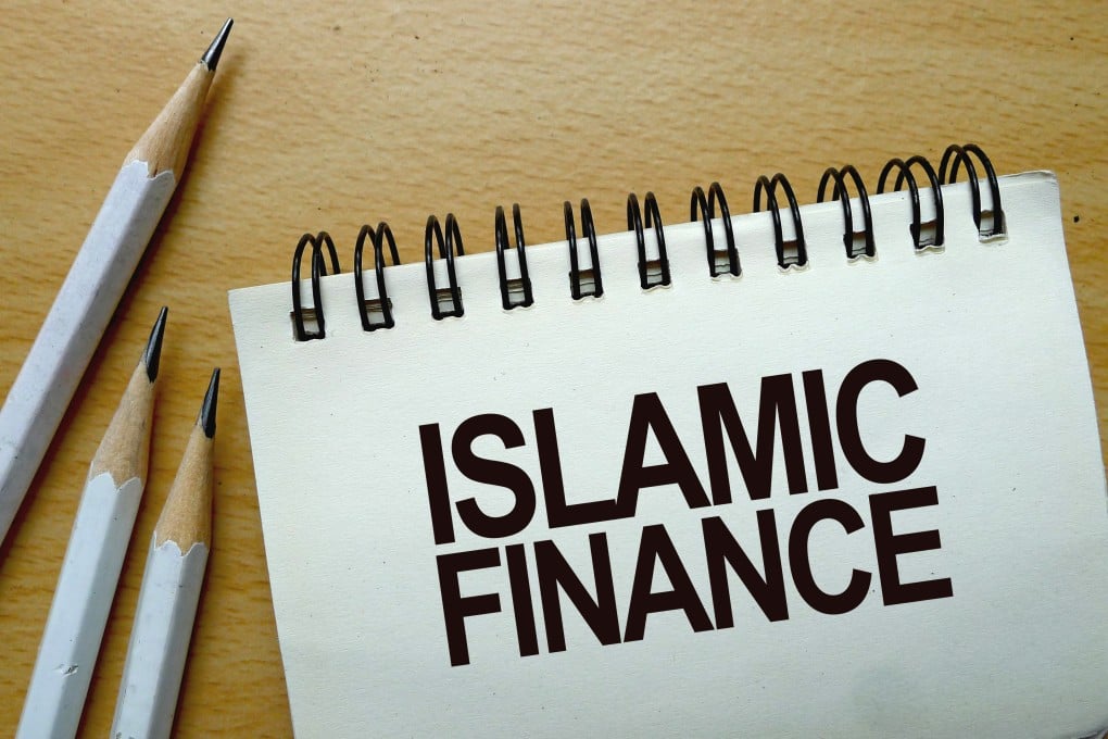 Islamic finance text written on a notebook with pencils. Photo: Shutterstock