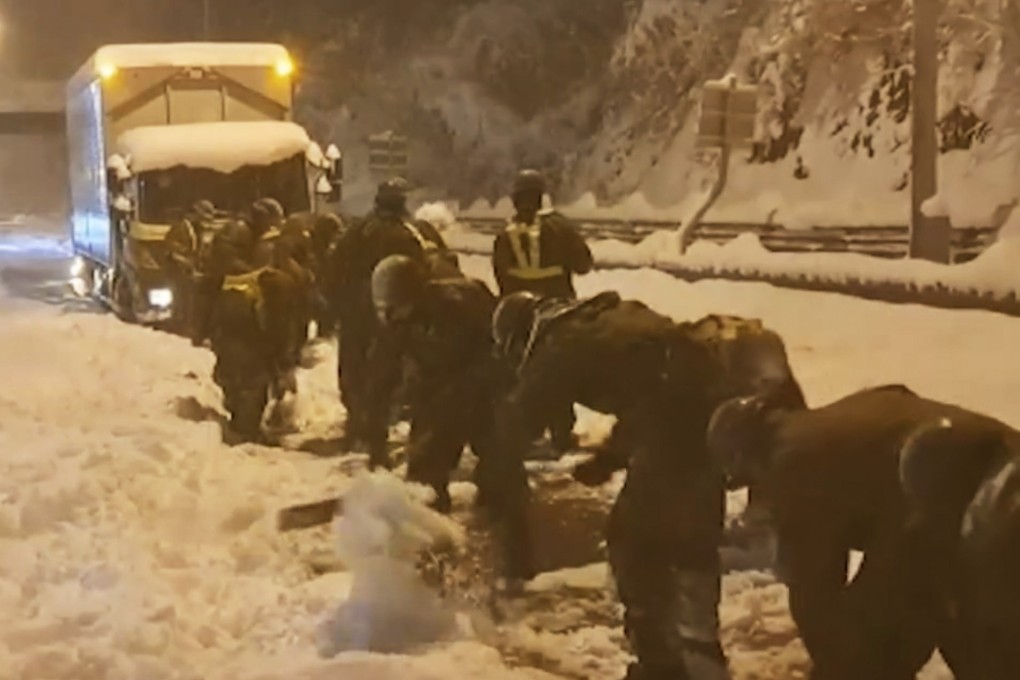 Japan Ground Self-Defense Force members clear snow on an expressway on Wednesday. Photo: apan Ground Self-Defense Force via AP