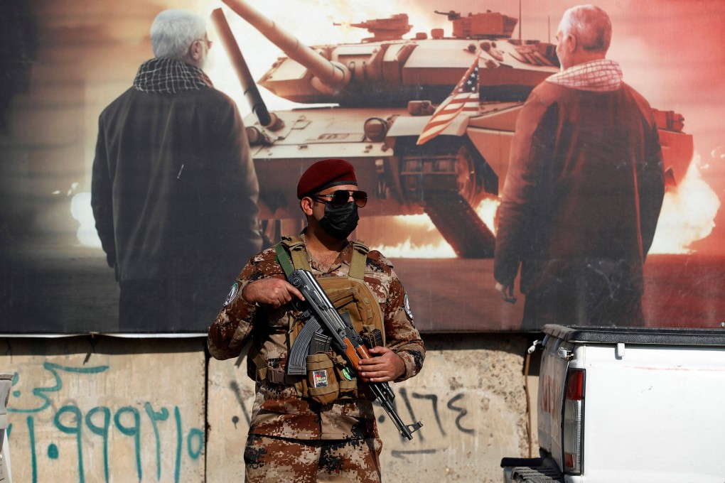 A paramilitary of the Hashed al-shaabi (Popular Mobilisation) forces stands guard during the funeral of a comrade, who died in American air strikes targeting Iran-backed groups the day before, at the Hashed al-shaabi forces’ headquarters in Baghdad, Iraq on Thursday. Photo: AFP