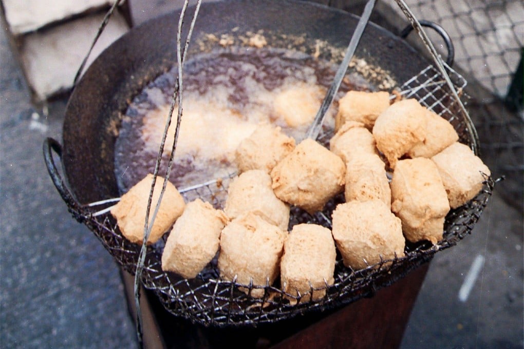 Blocks of fermented bean curd are deep-fried to make
stinky tofu at a streetside snack stall in Hong Kong. Fermented tofu is a staple of cuisines across China and the diaspora. Photo: SCMP