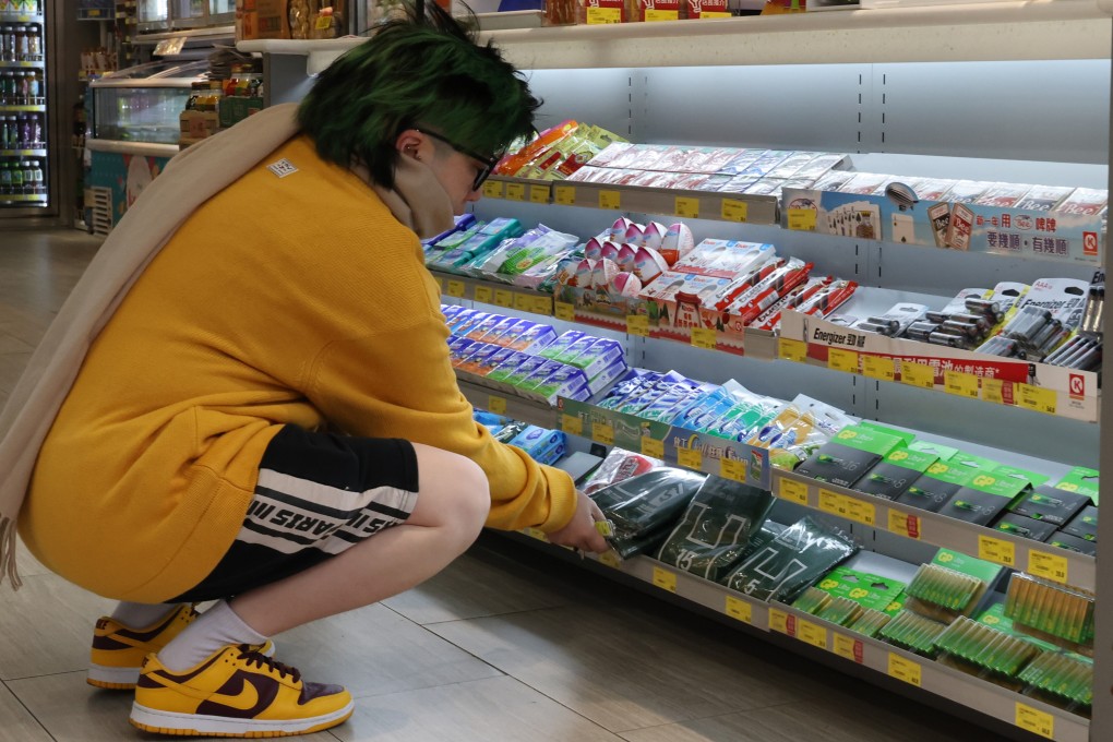 A woman buys a designated rubbish bag at a convenience store in Mong Kok. Photo: Jelly Tse