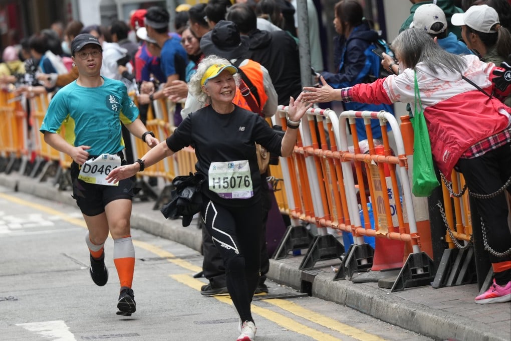 Runners enjoy the crowds in Causeway Bay during the Hong Kong Marathon event on January 21. Photo: Eugene Lee