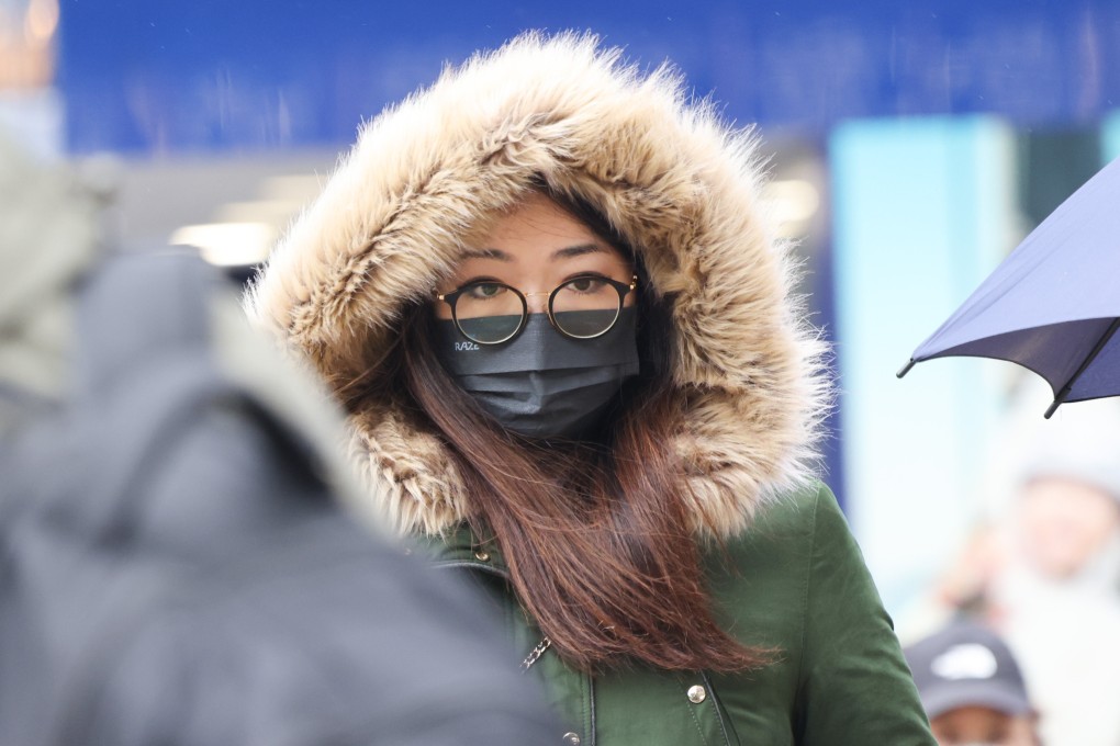 A woman wraps up warm against the chill in Tsim Sha Tsui. Photo: Jelly Tse