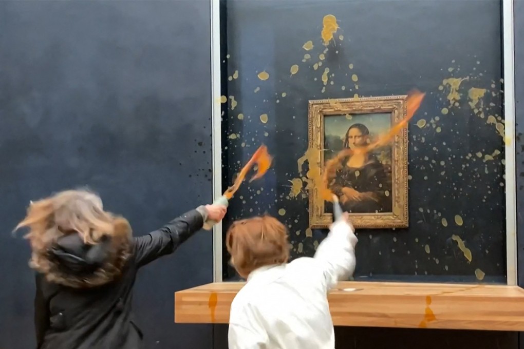 Environmental activists take aim at Leonardo Da Vinci’s famous Mona Lisa painting in Paris on Sunday. Photo: AFP