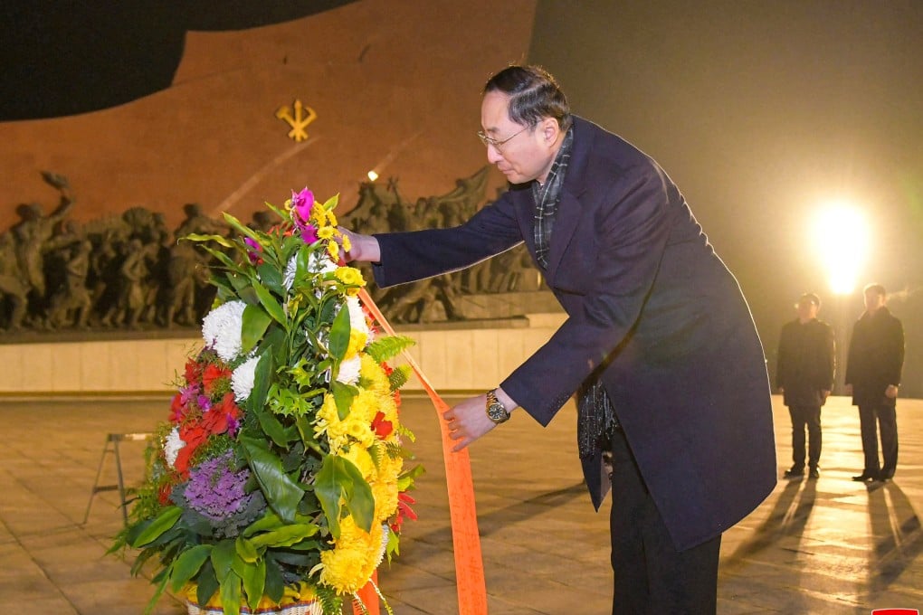 Chinese foreign vice-minister arranges a floral tribute as he visits the statues of former North Korean leaders in Pyongyang on Friday. Photo: KCNA via Reuters
