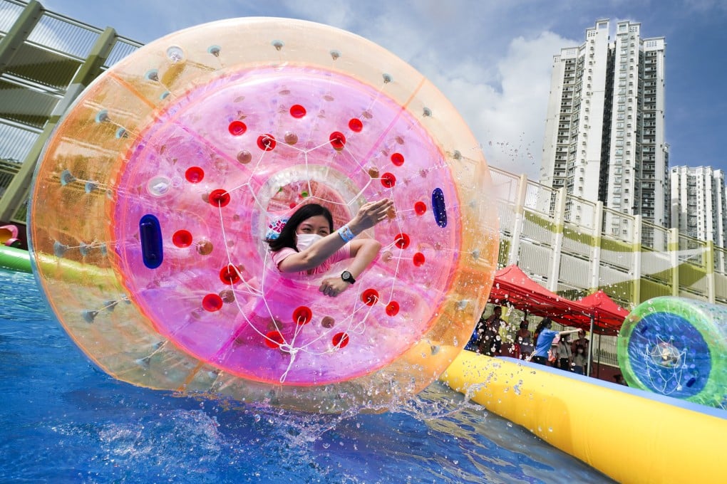 People play water games in Tin Shui Wai in 2022. Enjoyable activities around the city should be promoted in English, to make sure that expats feel included. Photo: Felix Wong