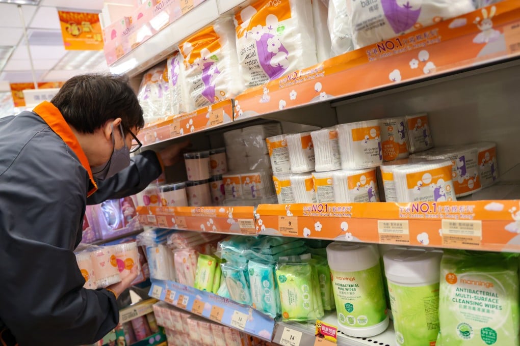 A shopkeeper restocks shelves with cotton buds. Authorities have sought to clear up confusion about which products are included in the first phase of the ban. Photo: Jelly Tse