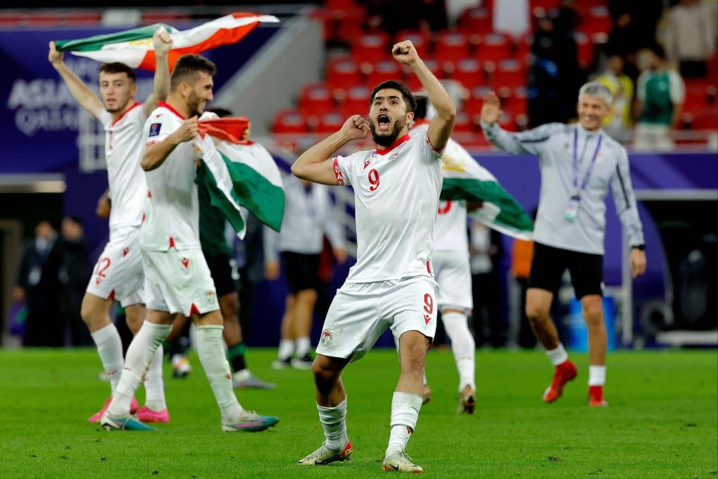 Tajikistan’s Rustam Soirov and some teammates celebrate after beating the United Arab Emirates in the last 16 of the Asian Cup. Photo: AFP