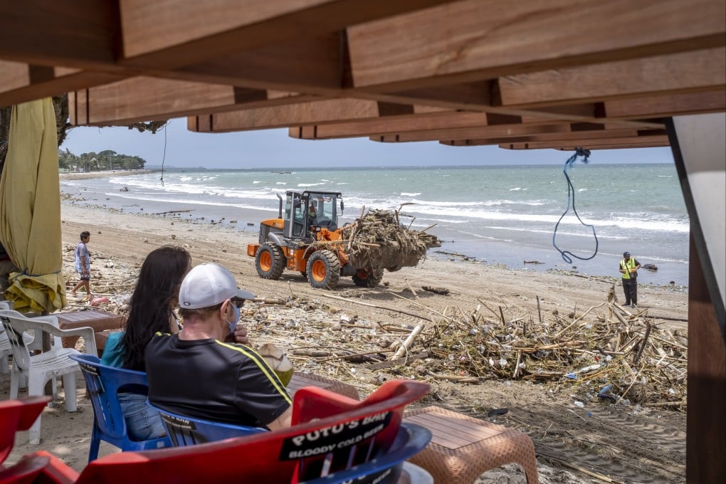 Workers clean debris and plastic waste in Kuta. More than four million intentional holidaymakers visited the island in the first 10 months of 2023. Photo: EPA-EFE